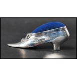A 925 silver Victorian style pincushion in the form of a shoe. Marked 925. Weight 19g. Measures