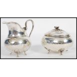 An early 20th century continental 800 silver marked lidded sugar bowl and creamer milk jug. Both