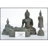 A group of four 19th century Oriental Chinese bronze Buddhas modelled in a reclined position,