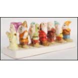 A vintage 20th century Snow White and he Seven Dwarfs ceramic toast rack. Measures 20cm long.