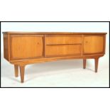 A vintage large 6ft  mid century teak wood sideboard in the Danish manner having central drawers