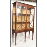 An Edwardian mahogany chippendale revival large  display cabinet. Raised on square tapered legs with