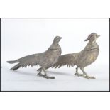 A brace pair of vintage 20th century silver plated pheasants of typical form.
