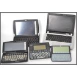 A collection of early 21st century electronic note pad computers to include Psion all with leads.