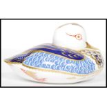 A Royal Crown Derby Teal paperweight, with red stamp to underside, silver stopper, 6cm high and 12cm