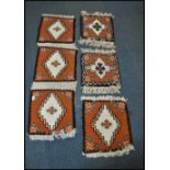 A group of five 20th century Kelim woolen rug panels, each on cream ground with a central medallion,