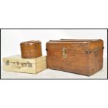 A group of early 20th century vintage luggage to include a vintage grained tin trunk with lock to