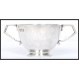 An early 20th century silver hallmarked twin handled cup bearing London hallmarks dating to 1904.