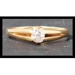 An antique 18ct gold and diamond solitaire ring having a single old cut diamond in a claw setting