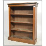 A Victorian oak open window bookcase being raised