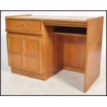 A retro 1970's Nathan furniture teak wood pedestal desk. The open kneehole recess flanked by a qtr