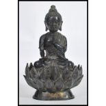 A 19th century Oriental Chinese bronze Buddha modelled in the lotus position raised on a pedestal