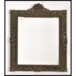 A 20th century Italian cast metal Florentine revival wall mirror having a pierced frame with