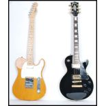 Two 20th century electric six string guitars, one being a Squire stratocaster style guitar