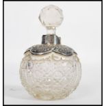 A 19th century Victorian silver hallmarked perfume bottle of globular form. The faceted glass body