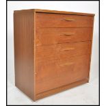 A retro 20th century Danish inspired teak wood chest of drawers. Raised on inset plinth with central