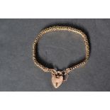 A 9ct gold heart padlock clasp bracelet chain. With safety chain. The clasp stamped 9ct. Tests as
