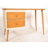 A retro mid century students bureau desk being raised on tapering legs of beech wood supporting a