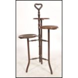 An early 20th century mahogany tiered wine stand. The central column with  three staggered