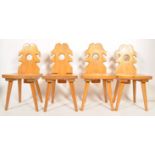 A set of 4 retro mid century Polish folk - country dining chairs of pine constuction being raised on