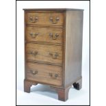 An early 20th century mahoganys square fronted pedestal  chest of four drawers with drop swag