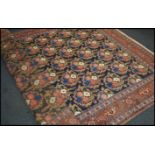 A good large 20th century wool and silk rug / carpet, on red ground with a central floral panel,