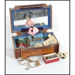 A vintage jewellery box containing a collection of vintage silver and costume jewellery to include
