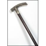 A 19th century Chinese silver walking stick cane. The tapering ebony shaft with silver dragon handle