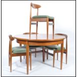 G-Plan - A retro 1960's teak wood extending dining table of round form raised on tapering legs