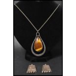 A silver and tigers eye large pendant necklace having a rope twist chain with bolt ring clasp.