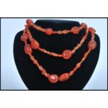 A vintage orange agate stone bead necklace of varied graduating form. Measures 64cm long.