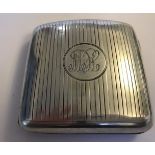 A hallmarked silver engine turned cigarette case with hidden photograph compartment.  The case
