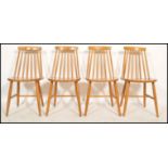 A set of four vintage retro mid 20th century Danish influence dining chairs raised on tapering
