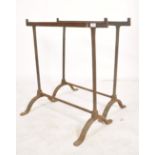 A pair of early 20th century workmens cast metal trestle ends - coffine stands ideal for