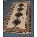 A 20th century Kelim woolen rug / runner , on cream ground with a central medallions, inner border