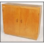 A vintage 20th century large Industrial school cabinet having twin doors with appointed shelved
