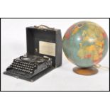 A vintage mid 20th century Encyclopedia Britannia globe raised on circular wooden base along with