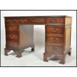 A 20th century antique Georgian revival mahogany and leather twin pedestal writing desk having an
