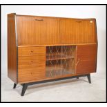 A 1950's - mid century retro sideboard - highboard having a series of fall front cabinets over