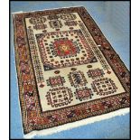 A 20th century Kelim woolen rug, on cream ground with a central medallion, inner border with