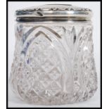 A large early 20th century silver hallmarked topped cut glass dressing table pot. Hallmarked for