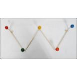 A vintage retro sputnik atomic set of coat hooks in a painted white finish with multi coloured