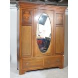 A large Edwardian mahogany double wardrobe being raised on a plinth base with deep drawer. Above a