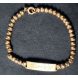 An 18ct gold vintage ladies bracelet chain having ball links with monogrammed name panel and bolt