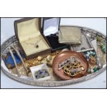 A collection of vintage silver and costume jewellery to include a silver bracelet, charm