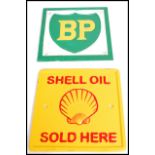 A pair of square vintage style cast metal point of sale advertising garage wall plaques for Shell