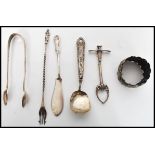 A group of silver hallmarked flatware to include a pickle fork with twist stem and apostle finial, a