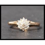 A hallmarked 9ct gold and diamond cluster ring. Weight 2.1g. Size M.5.