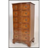 A good quality upright serpentine fronted mahogany chest of drawers being raised on bracket feet