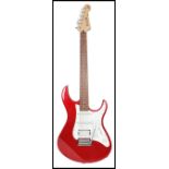 A vintage 20th century Yamaha electric six sting guitar. The shaped red body having a white